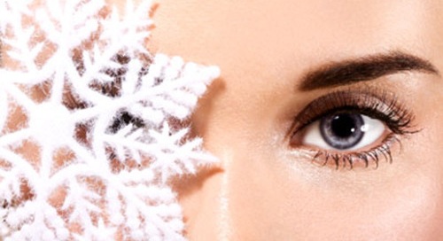 Woman eye with snowflake closeup